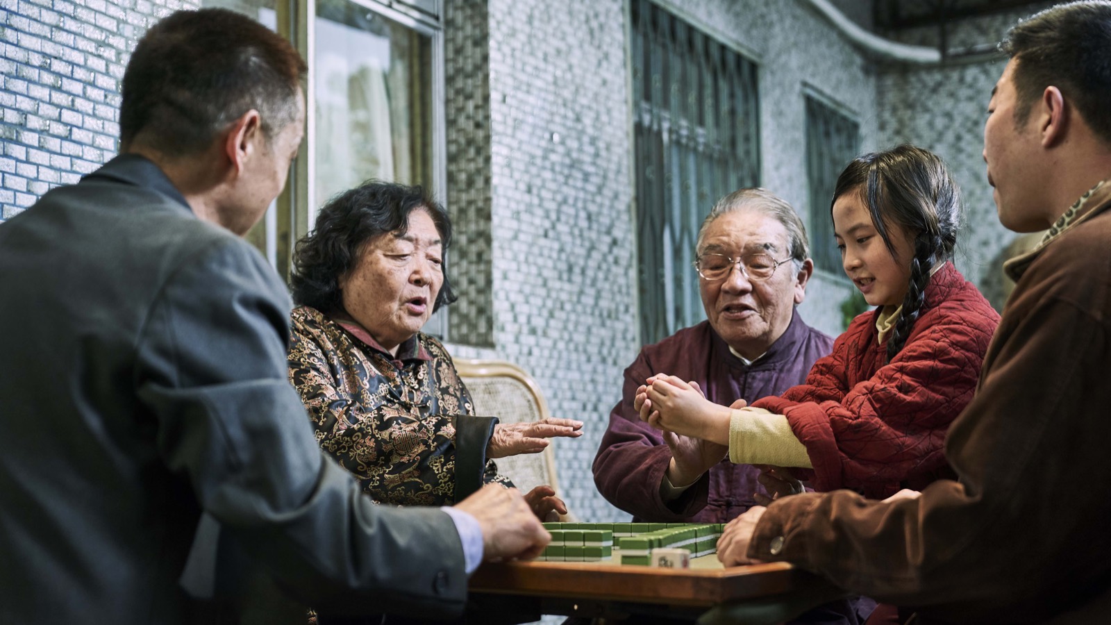 Yang Lan playing mahjong with her family