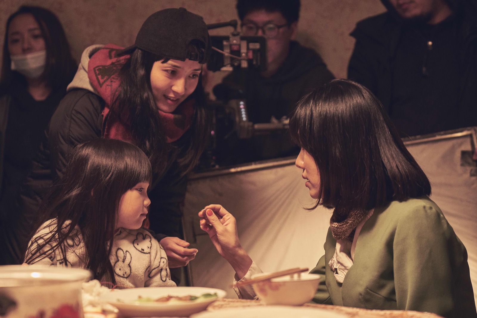 Jae Yang directing a scene with the young actor