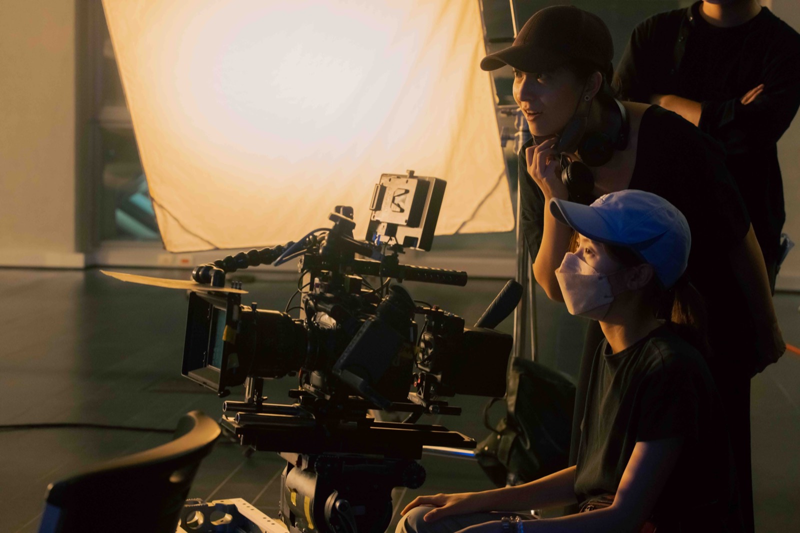 Jae Yang and the cinematography team reviewing a shot