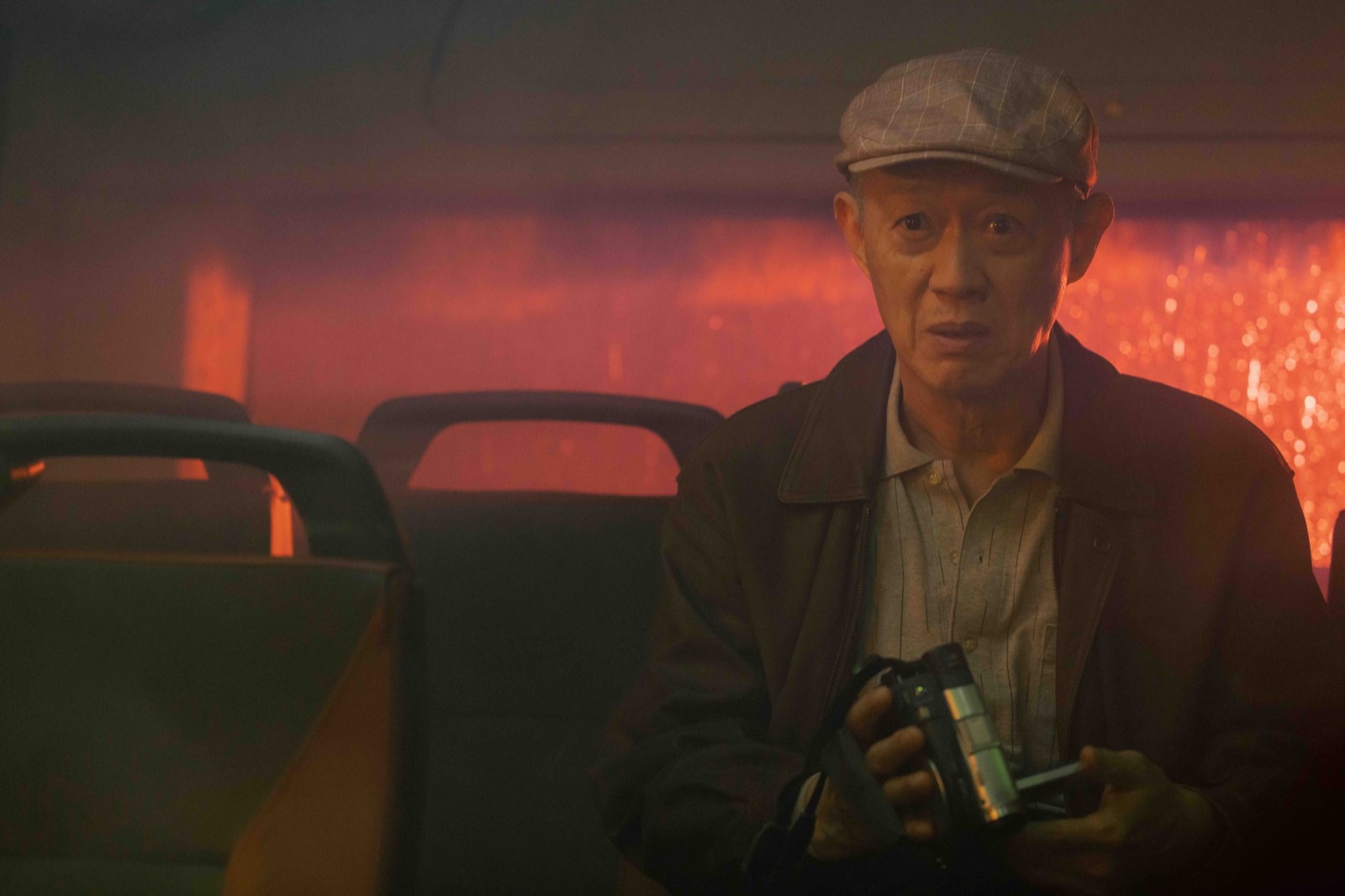 Mr. Wu sitting alone on the bus