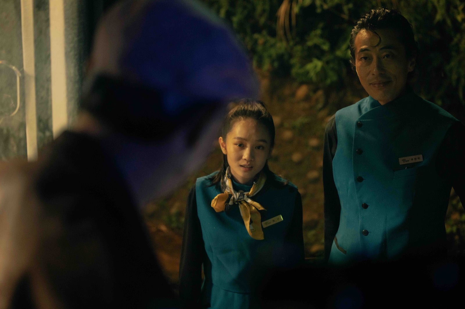 Two Hell airport attendants greeting a passenger