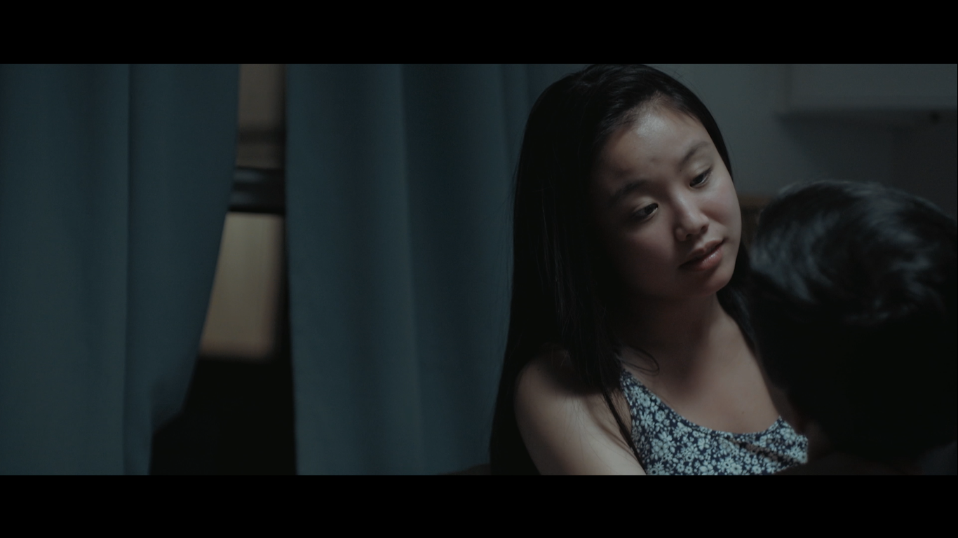 A woman speaking closely to another person