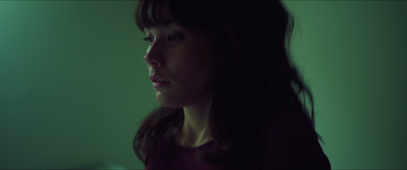 Sophia alone in green light