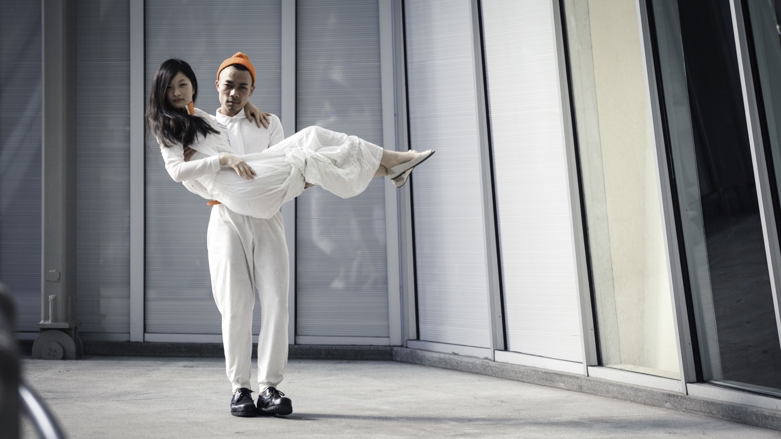 Starry Eyes behind the scenes: the art director carries a performer dressed in white