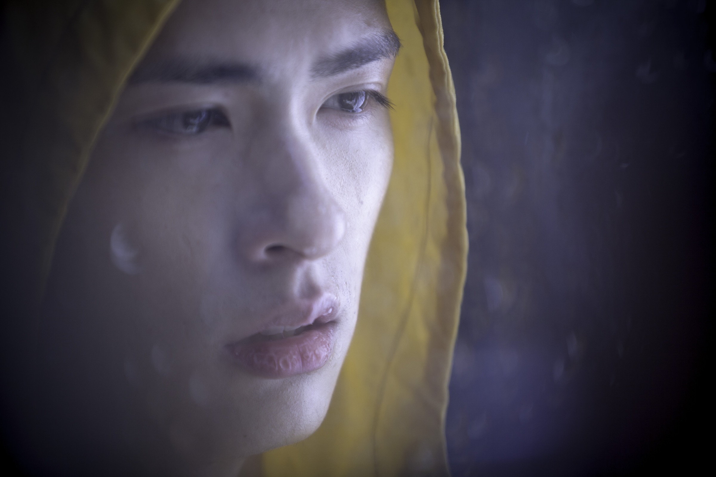 Starry Eyes still: a woman framed by a yellow hood