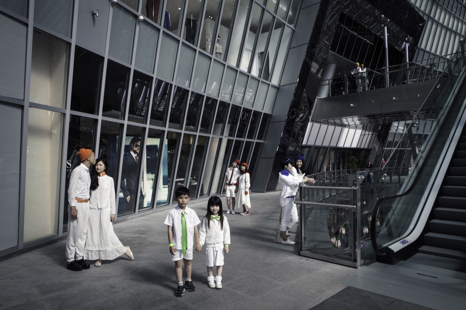 Starry Eyes still: couples and children gather in a futuristic atrium
