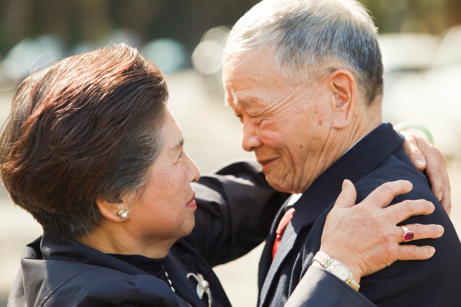 Starry Eyes still: an elderly couple embraces outdoors