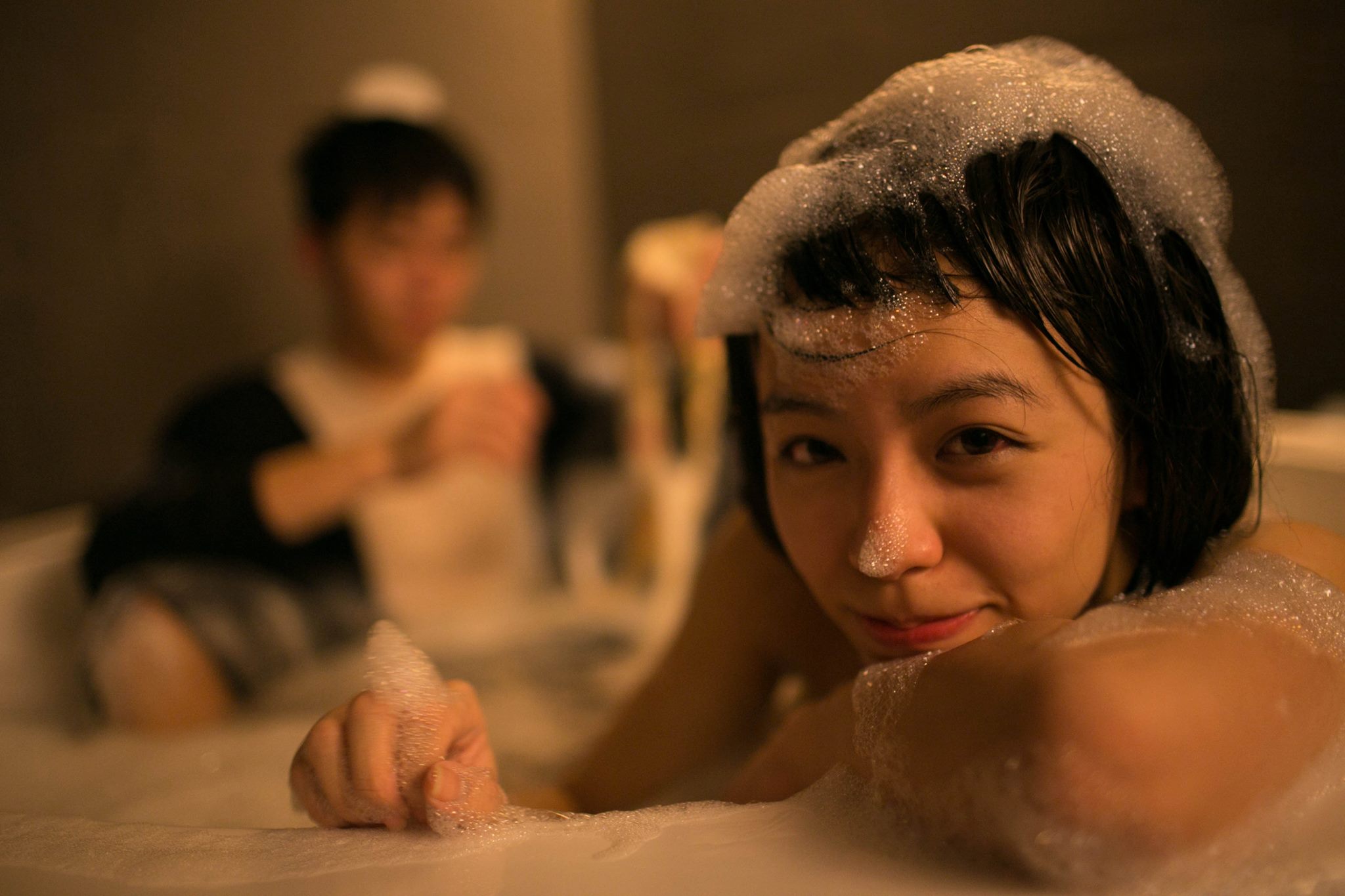 Starry Eyes still: a woman surrounded by bubbles in a bath